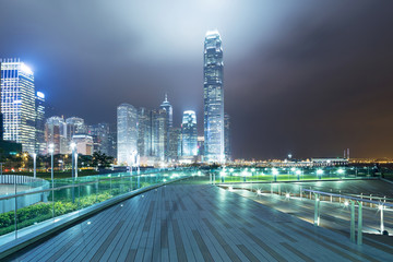 Fototapeta na wymiar pathway in the night with modern city background