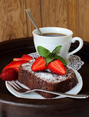 Slice of chocolate cake with strawberries