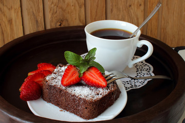 Slice of chocolate cake with strawberries