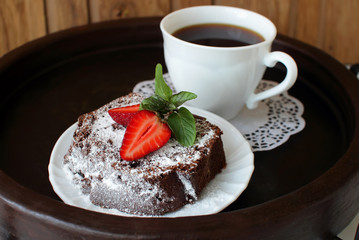 Slice of chocolate cake with strawberries