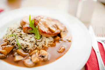 Juicy,  succulent grilled pork chops with mushrooms and rice