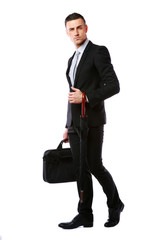 businessman standing with laptop bag and umbrella