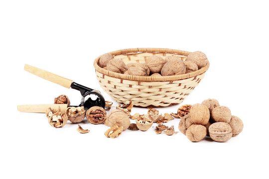 Walnuts in basket and nutcracker.