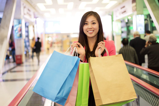 Smiling girl with shopping bags