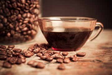 Cup of black coffee with beans