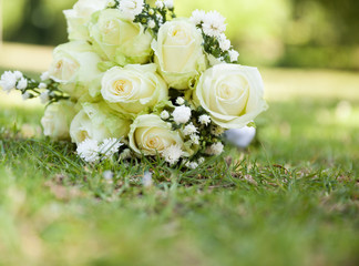Bridal bouquet on grass at the park - 63419858