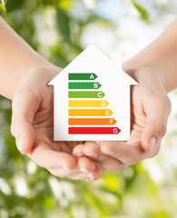 hands holding white paper house