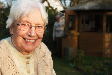 Elderly woman with walking frame in the garden