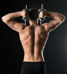 bodybuilder doing exercises with dumbbells