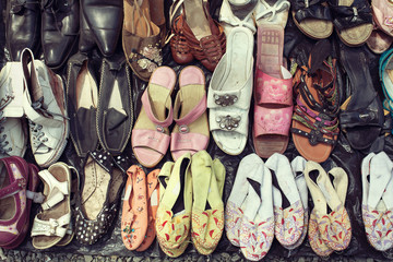 Male and female used shoes at the flea market