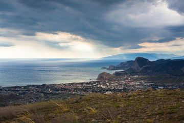 city ​​by the sea near the mountains under a beautiful sky