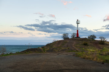 white-red lighthouse on the seafront
