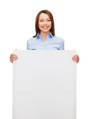 Fototapeta premium smiling businesswoman with white blank board
