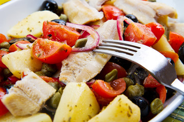 insalata di aringhe, patate, pomodori e olive