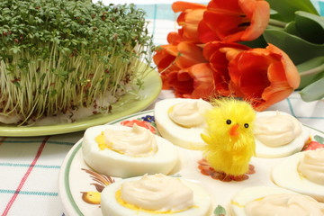 Halves of eggs with mayonnaise and Easter decoration