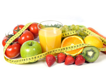 fruit , vegetables and orange juice wrapped in measure tape