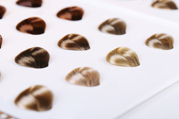 Hair samples of different colors on white background