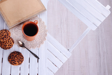 Composition with cup of hot drink and cookies