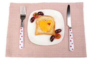 Scrambled eggs with bread on plate, on color napkin