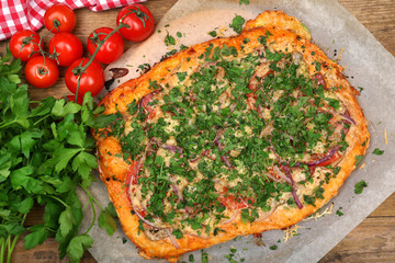 Homemade pizza on baking paper close up