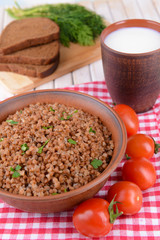 Boiled buckwheat in bowl on table close-up