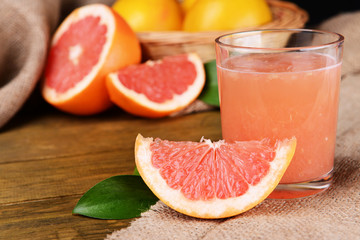 Fototapeta na wymiar Ripe grapefruit with juice on table close-up