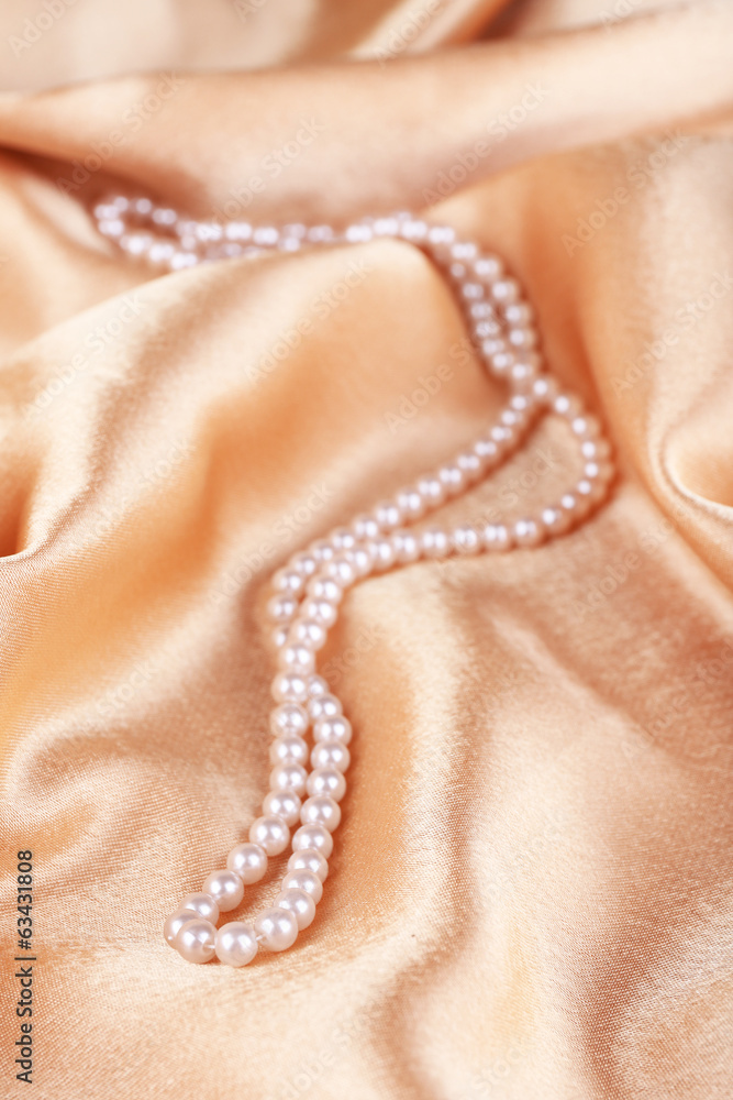 Wall mural Beautiful pearls on golden silk cloth