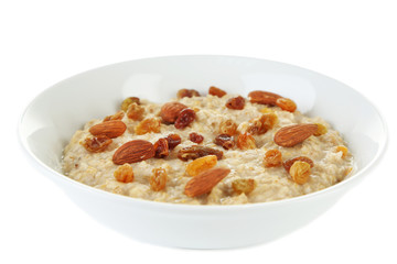 Tasty oatmeal with raisins isolated on white
