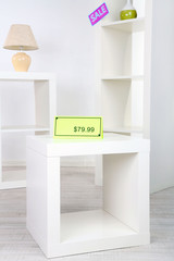 New white shelves with prices on light background