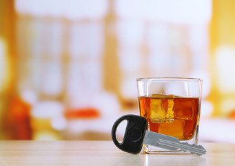 Composition with car key and glass of whiskey,
