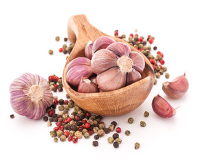 Garlic cloves in wooden bowl isolated on white background
