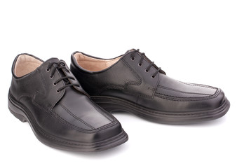 Black glossy man’s shoes with shoelaces