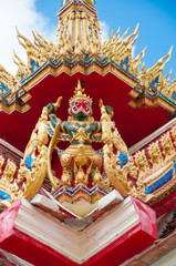 Fototapeta na wymiar Garuda statue on top of traditional Thai style church