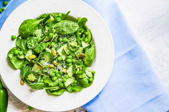 Green salad with spinach,pepper,sweet peas and parmesan on rusti