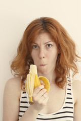 Young Woman Eating a Banana