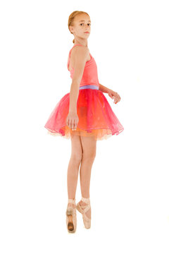 young female ballerina on pointe wearing pink outfit