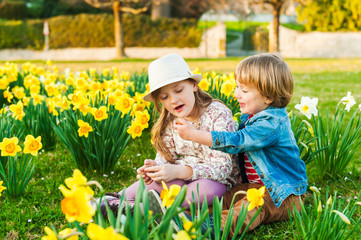 Adorable children playing with flowers