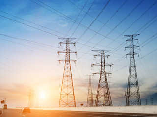 High-voltage tower sky background,besides the highway.