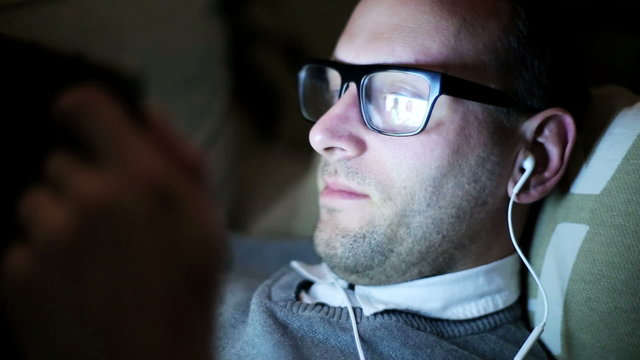 Man watching picture on tablet, closeup.