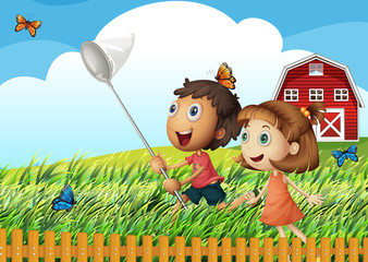 Fototapeta premium Kids catching butterflies at the field