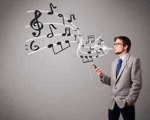 handsome boy singing and listening to music with musical notes