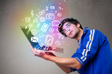 Casual man holding laptop with colorful hand drawn multimedia sy