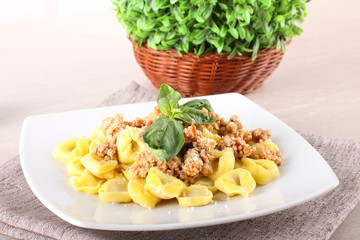 Tortellini with meat sauce and basil - 63442883