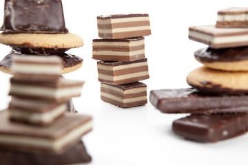 Stack of chocolate pieces on a white background