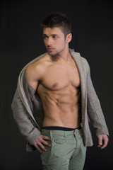 Fototapeta premium Attractive young man with open jacket on muscular torso