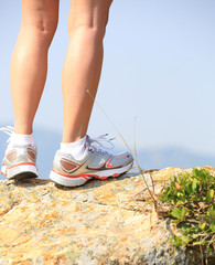 woman hiker legs  at  seaside mountain rock