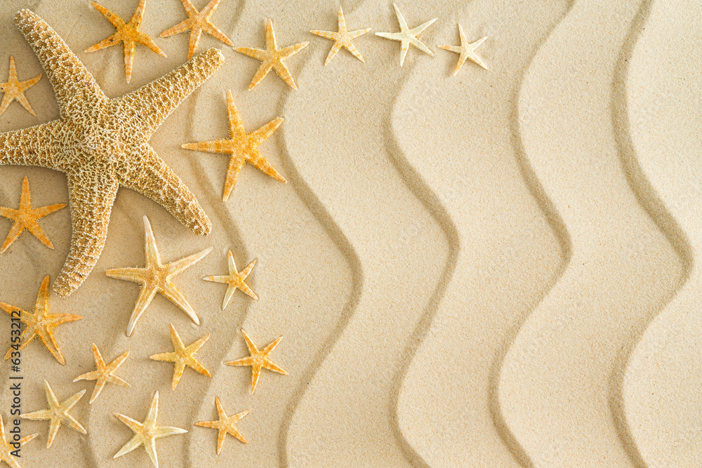 Wall mural starfish on golden beach sand with wavy lines