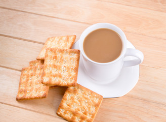 Coffee cup on the table with bread sticks.