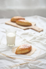 Cabbage buns with glass of milk and wheat ears