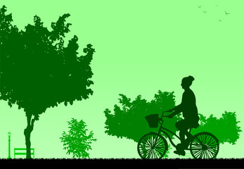 Girl bike ride in park in spring silhouette
